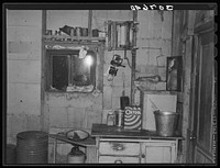 Kitchen in dust storm area with window sealed with towels. Williams County, North Dakota by Russell Lee