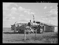 Old steam tractor and threshing machine, idle for nine years. Ellisville Township, Williams County, North Dakota by Russell Lee