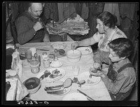 Noonday meal of Ole Thompson family, Williams County. No vegetables, but chicken because it is cheapest meat as it is raised on the farm by Russell Lee