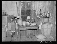 New Madrid County, Missouri. Child of sharecropper getting drink of water in kitchen of shack by Russell Lee