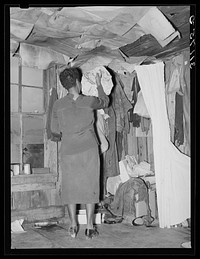 New Madrid County, Missouri. Space for clothes storage in sharecropper shack by Russell Lee