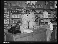 Making a sale, Lake Dick cooperative store. Lake Dick Project, Arkansas by Russell Lee