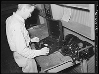 Conducting moisture tests on sample of rice. State rice mill, Crowley, Louisiana by Russell Lee