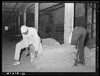 Sewing burlap sacks. State rice mill, Crowley, Louisiana by Russell Lee