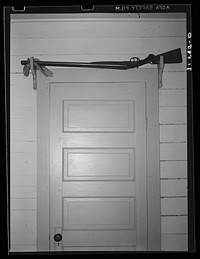 [Untitled photo, possibly related to: Shotgun over the door for sake of quick availability in farmer's home. Crowley, Louisiana] by Russell Lee