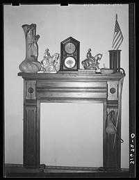 Mantle and fireplace in home of Madame Dronet. Erath, Louisiana by Russell Lee