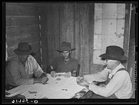 [Untitled photo, possibly related to: End of hand of poker played by day laborers at home near New Iberia, Louisiana] by Russell Lee