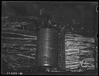 [Untitled photo, possibly related to: Feeding sugarcane into crusher at sugar mill near New Iberia, Louisiana] by Russell Lee