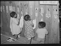 Child wiping hands after washing. Lakeview nursery school. Arkansas by Russell Lee