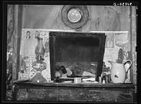 Mantel in sharecropper's home. Transylvania, Louisiana by Russell Lee
