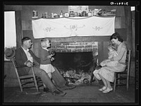 Bagget family in front of fireplace which is means of heating in the winter. Laurel, Mississippi by Russell Lee