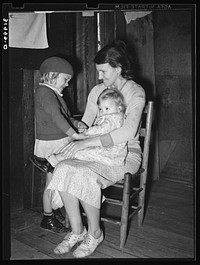Mrs. Bagget and two children. Wife of sharecropper near Laurel, Mississippi by Russell Lee