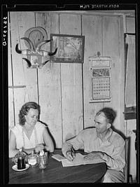 FSA (Farm Security Administration) client and wife noting farm income in ledger. Hidalgo County, Texas by Russell Lee