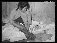 Mexican mother with three days old baby, born in this home. Crystal City, Texas by Russell Lee