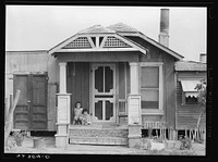 Front of Mexican house. Edcouch, Texas. Decorations on door step are bottle caps by Russell Lee