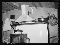 Kitchen range and homemade ventilator in trailer belonging to white migrant camped at Sebastian, Texas by Russell Lee