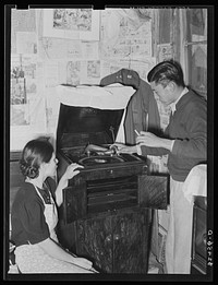 Mexican boy and girl playing phonograph. San Antonio, Texas. The Mexicans love all forms of music by Russell Lee