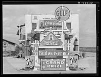 Signs in front of highway tavern. Crystal City, Texas by Russell Lee