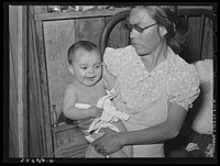 Mexican mother with child with impetigo. Crystal City, Texas by Russell Lee