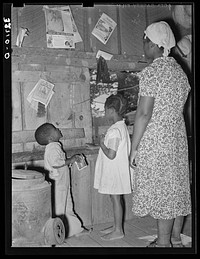 Wife of  sharecropper teaching her children their ABCs. Near Marshall, Texas by Russell Lee