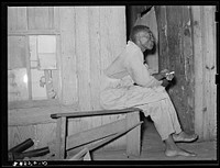 Strawberry sharecropper on front porch of his home near Hammond, Louisiana. He said that in a good year he came out with maybe two hundred dollars by Russell Lee