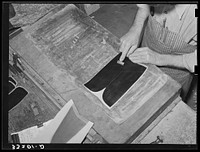 Smoothing out wrinkles after gluing lining into upper part of boots. Bootmaking shop, Alpine, Texas by Russell Lee