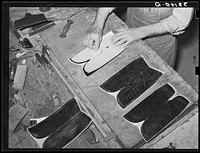 The pattern for the stitching on the uppers is transferred to the leather by means of talc through perforations in the pattern. Boot making shop, Alpine, Texas. Each of the bootmakers has his own patterns which he has fashioned by Russell Lee