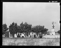 House in Midland, Texas, with its individual windmill to furnish water for yard, garden, and flowers by Russell Lee