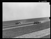 Tractor farming on 4900 acre ranch near Ralls, Texas by Russell Lee