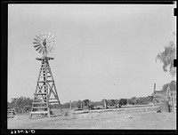 Windmill and watering trough on SMS Ranch near Spur, Texas by Russell Lee