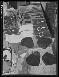 [Untitled photo, possibly related to: All the parts that go into the uppers of a pair of boots. Boot shop, Alpine, Texas] by Russell Lee