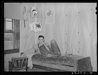 Son of woman tenant farmer on daybed in corner of living room near Sallisaw, Oklahoma by Russell Lee