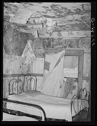 Bedroom of  agricultural day laborer living in small town in Muskogee County, Oklahoma by Russell Lee