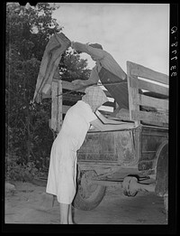 Migrant family loading truck preparatory to departure for California. Near Muskogee, Oklahoma by Russell Lee