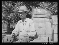 Water peddler in community camp. Oklahoma City, Oklahoma. He is paid fifteen cents a barrel for delivering water to the shack homes. See general caption no. 21 by Russell Lee