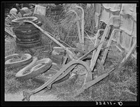 Old plows and wornout tires. Testimonial to the sources of the residents of the community camp. Oklahoma City, Oklahoma. See general caption no. 21 by Russell Lee