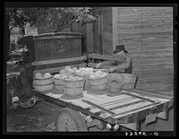 Tenant farmer loading melons and vegetables on his truck for delivery into market at Muskogee, Oklahoma. This year many vegetables were brought back from town when prices offered were ruinessly low and were there fed to hogs. Refer to general caption number 20 by Russell Lee