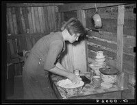 Resident of Mays Avenue camp making biscuits. Oklahoma City, Oklahoma. See general caption no. 21 by Russell Lee