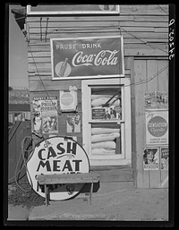 Detail of front of combined filling station and grocery store. Questa, New Mexico by Russell Lee