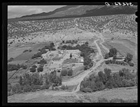 Spanish-American village along the Rio Hondo near Taos, New Mexico. The residents live in town and commute to their small farmlands on the outskirts of the town by Russell Lee