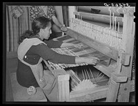 Running shuttle through warp in making rag rug at WPA (Works Progress Administration/Work Projects Administration) project at Costilla, New Mexico by Russell Lee