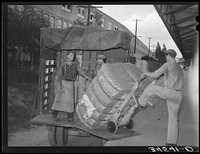 Unloading truckload of cotton. Compress, Houston, Texas by Russell Lee