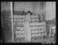 Piling picked turkeys on racks. Cooperative poultry house, Brownwood, Texas by Russell Lee