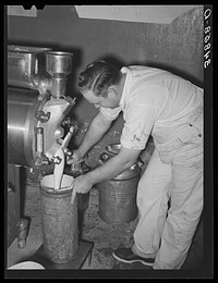 Filling can with ice cream mix. Creamery, San Angelo, Texas. Later it will be placed in freezer by Russell Lee