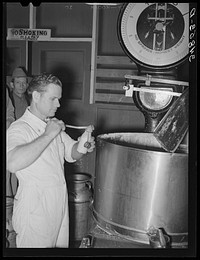 Taking sample of milk from weighing kettle to determine percentage of butter fat. Babcock test. Creamery, San Angelo, Texas by Russell Lee