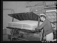 Getting ready to tuft a mattress in clamping machine. Mattress factory, San Angelo, Texas by Russell Lee