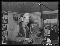 West Texan at eating house at auction. Stockyards, San Angelo, Texas by Russell Lee