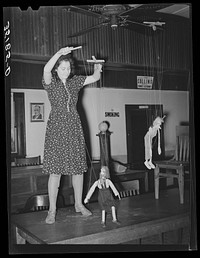 Member of the Red Dust Players, Oklahoma City theater group, operating puppets for the entertainment of meeting of UCAPAWA (United Cannery, Agricultural, Packing, and Allied Workers of America) members. Bristow, Oklahoma by Russell Lee