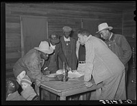 Conference of officials of local chapter of UCAPAWA (United Cannery, Agricutural, Packing, and Allied Workers) of America in Tabor, Creek County, Oklahoma. Pomp Hall, who is leaning on table at right, is an active leader in the union and in his community among both whites and es. See general caption number 23 by Russell Lee