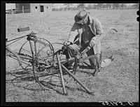 Pomp Hall,  tenant farmer, adjusting his cultivator so it will be in readiness for the spring planting. Creek County, Oklahoma. See general caption number 23 by Russell Lee